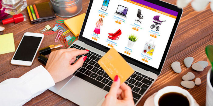 Woman shopping online on laptop and paying for purchased goods b Marketplaces eCommerce