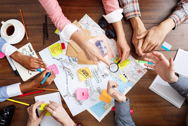 Picture of businessmen’s hands on wooden table with documents and drafts Equipos