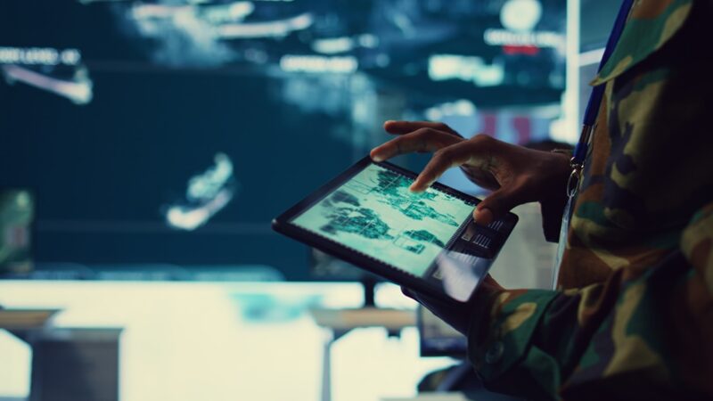 Army soldier reviews targets on satellite world map to ensure global protection SeismicAI